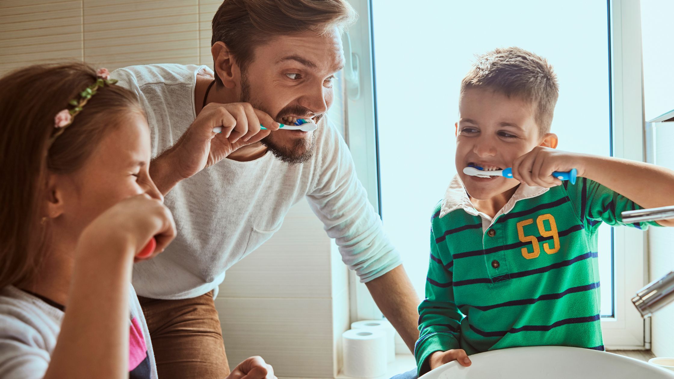 kids brushing teeth with dad