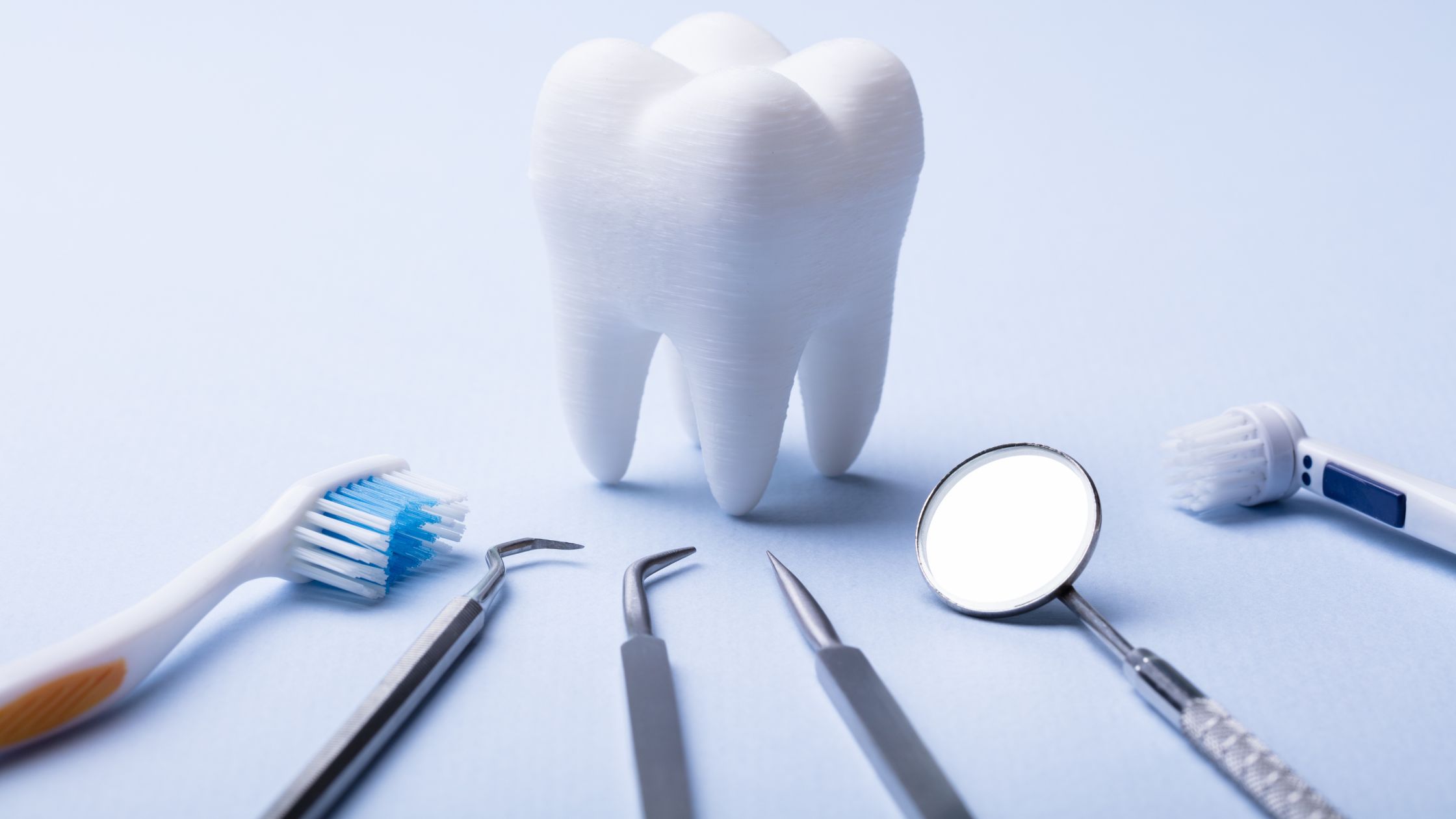 A set of dental tools including a toothbrush, toothpaste, and other essential items for oral hygiene