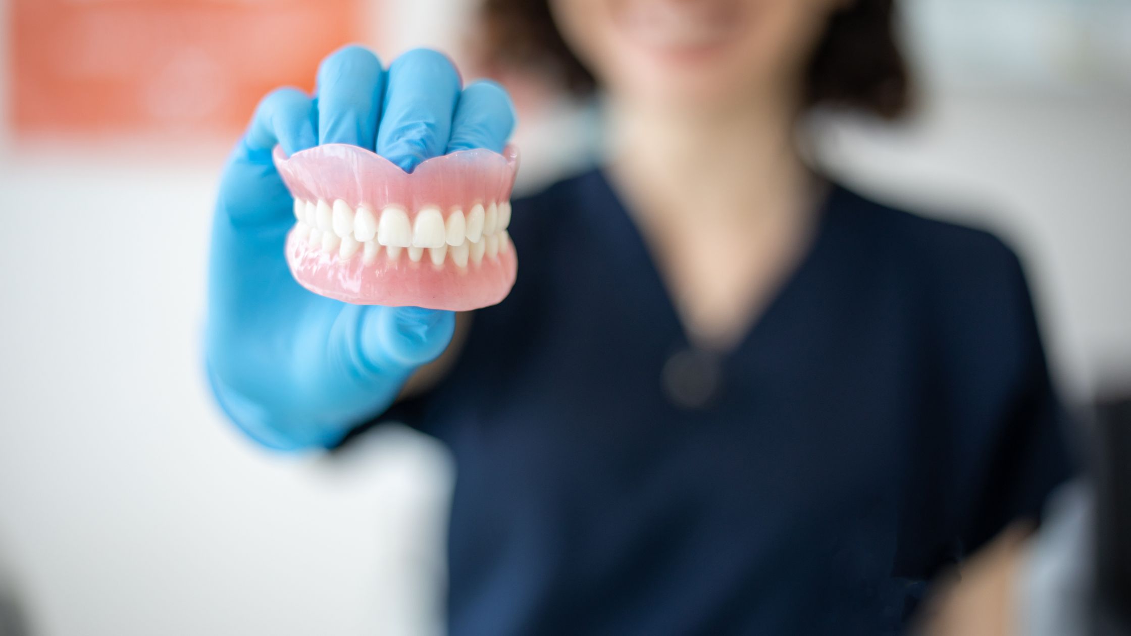 dentist holding dentures